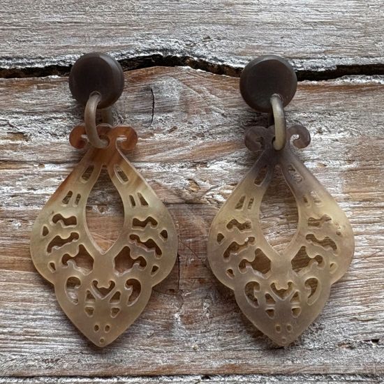 Sierlijk bewerkte buffelhoorn oorbellen 7.3x3.7 cm. Kleurvariaties. Matte finish. Lichtgewicht.