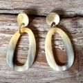 Stoere oorbellen buffelhoorn. Gevarieerde tintjes, mat. Lichtgewicht. Totale lengte 6.2cm.