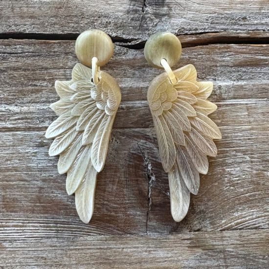 Lasergesneden buffelhoorn wings oorbellen, in lichte tintjes, mat. Totale lengte 7.5 cm.